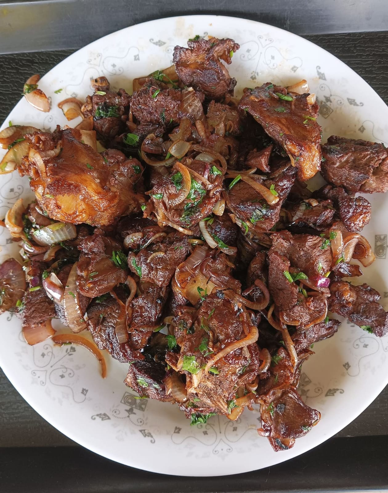 A plate of fried beef with onions and coriander served at Vipe Fun Park