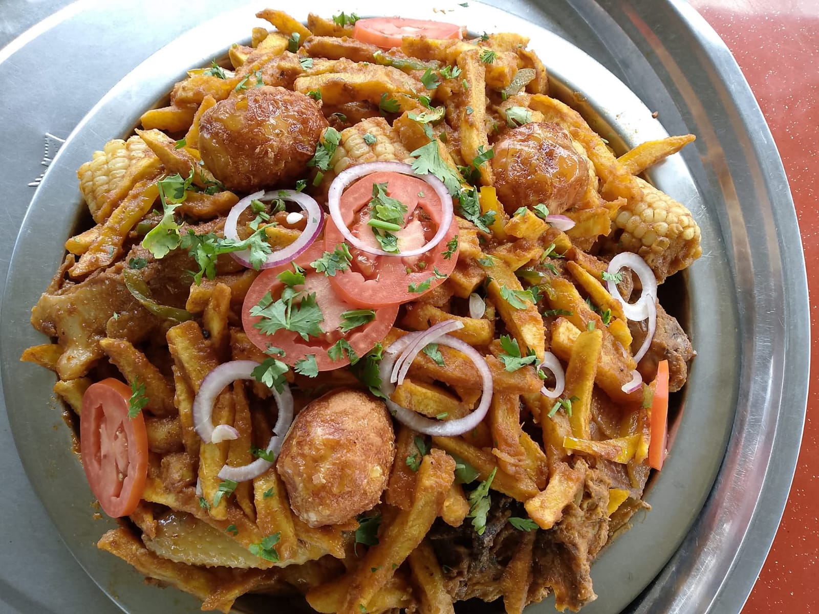 A shared platter of spiced chips with maize, onion rings, tomato and potato balls at Vipe Fun Park