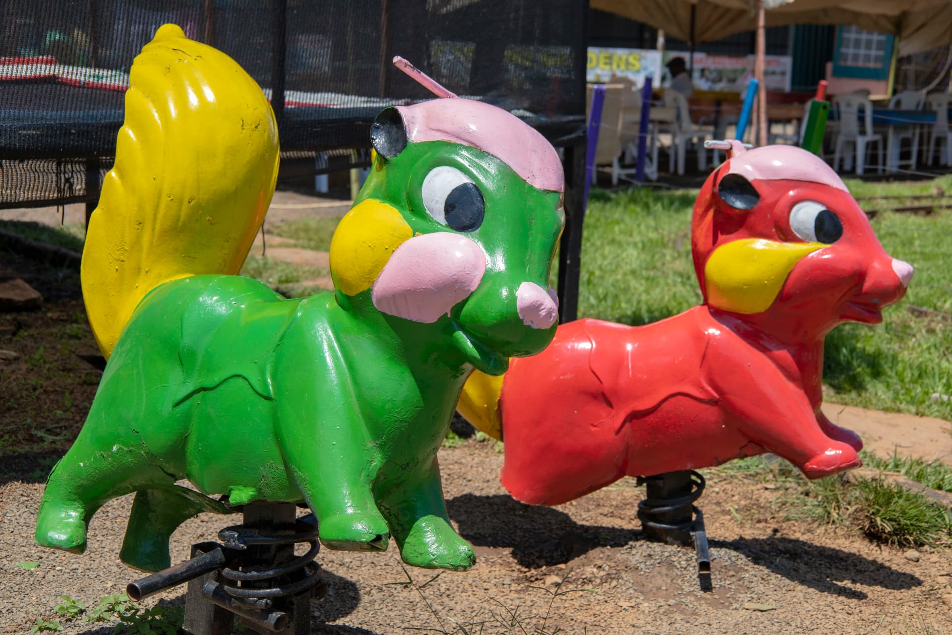 Green and red spring rocker rides shaped like animals at Vipe Fun Park