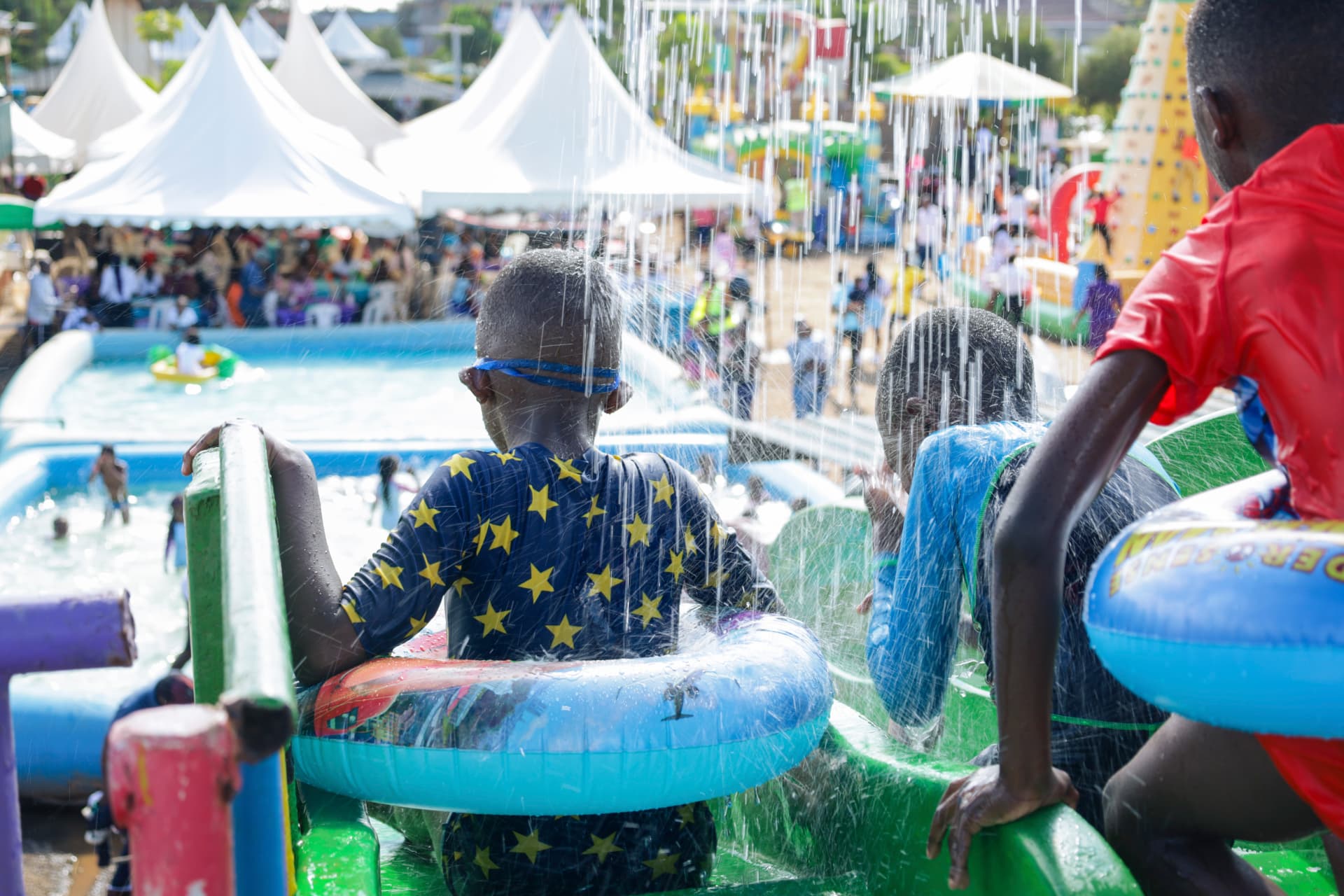 Children photographed from behind enjoying a colourful water ride at Vipe Fun Park