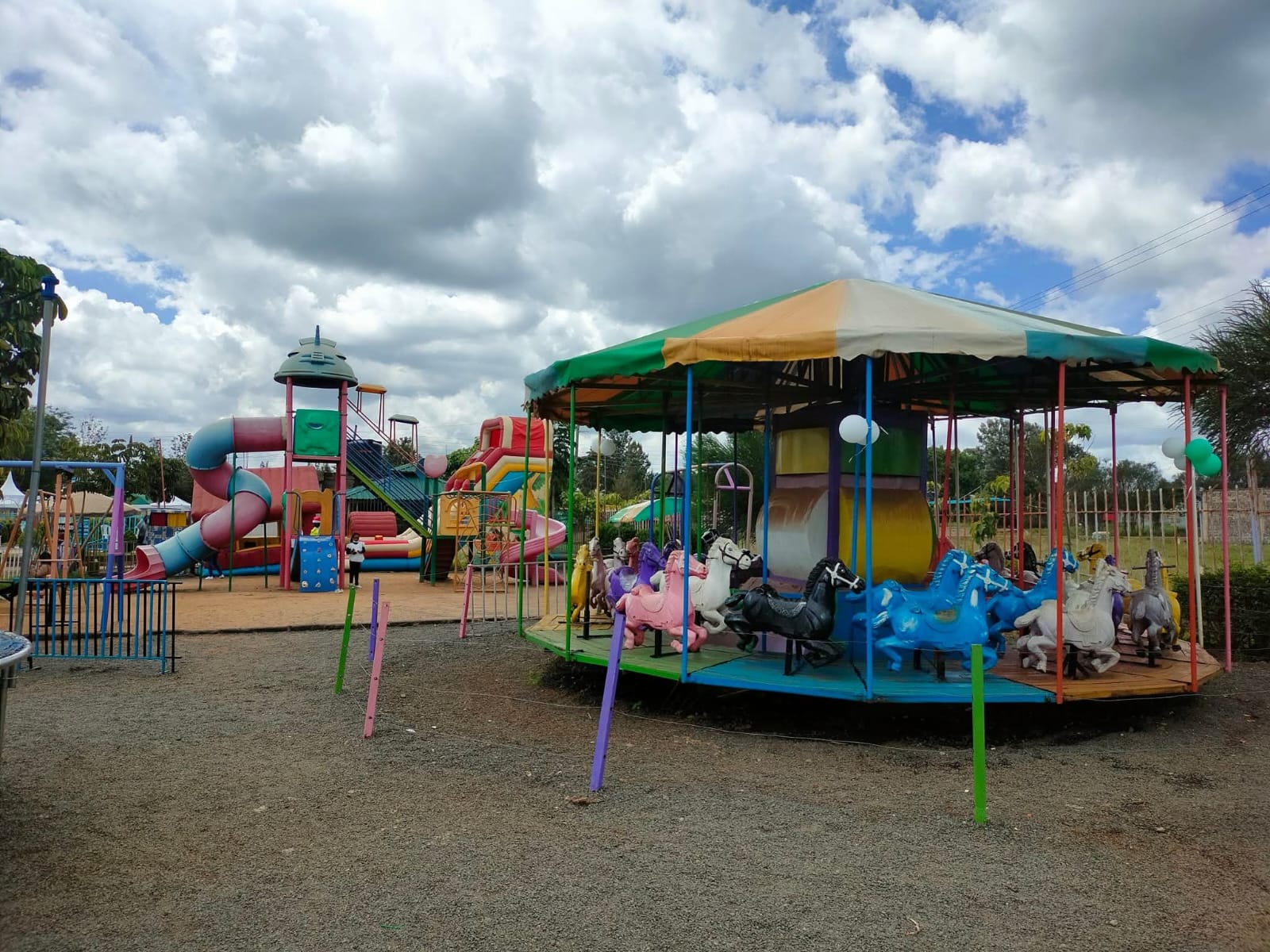The merry-go-round beside the slides and playground structures at Vipe Fun Park