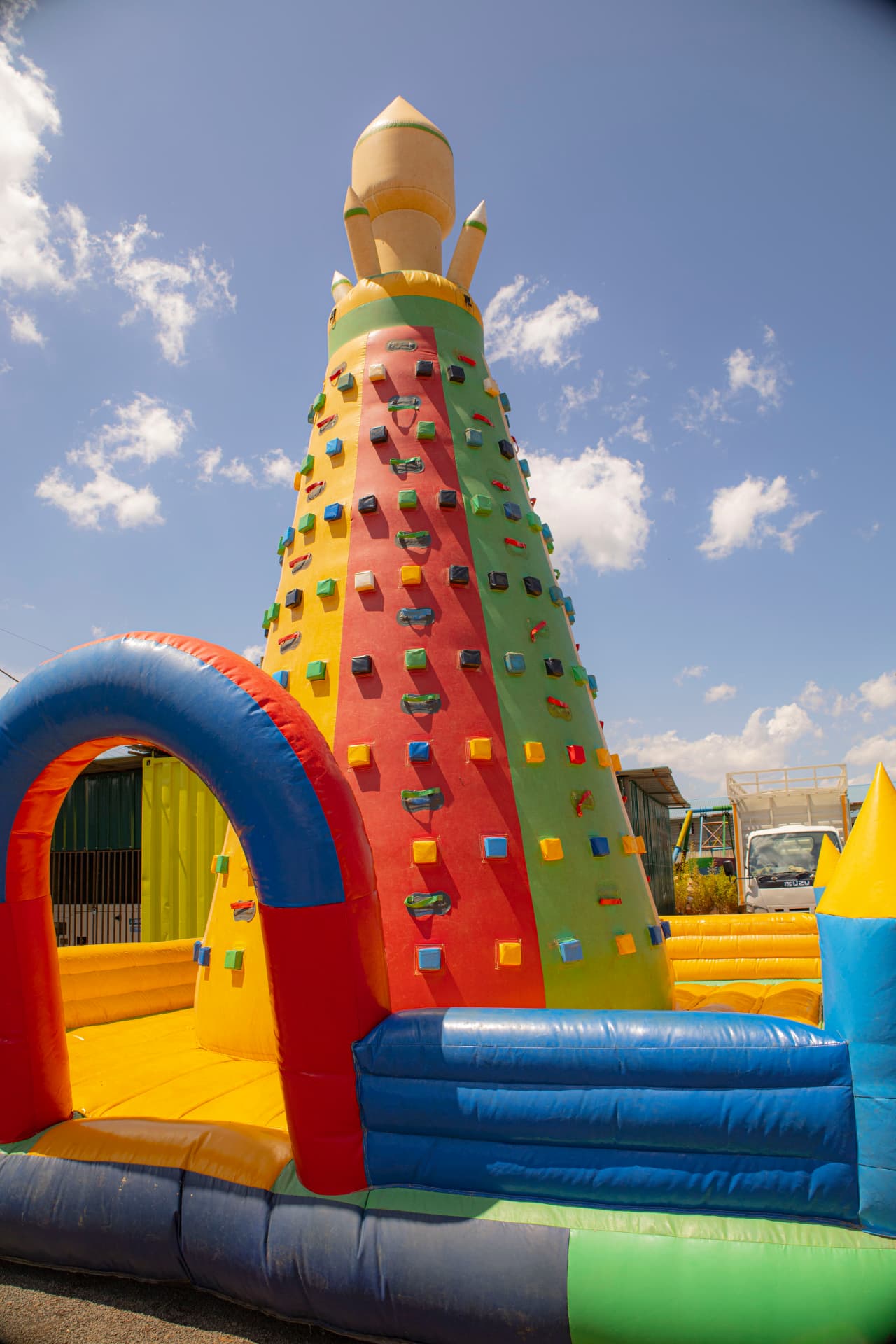 A tall inflatable climbing tower with colourful hand holds at Vipe Fun Park