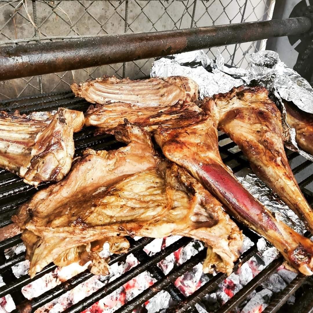 Cuts of meat roasting over glowing charcoal on the grill at Vipe Fun Park