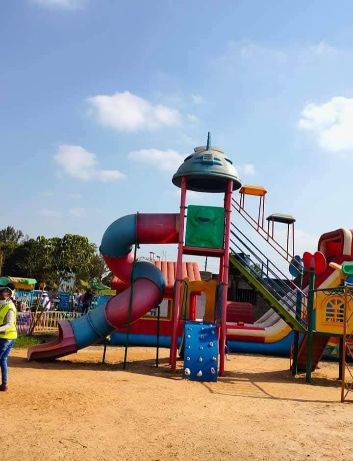 A tall playground tower with a tube slide and climbing wall at Vipe Fun Park