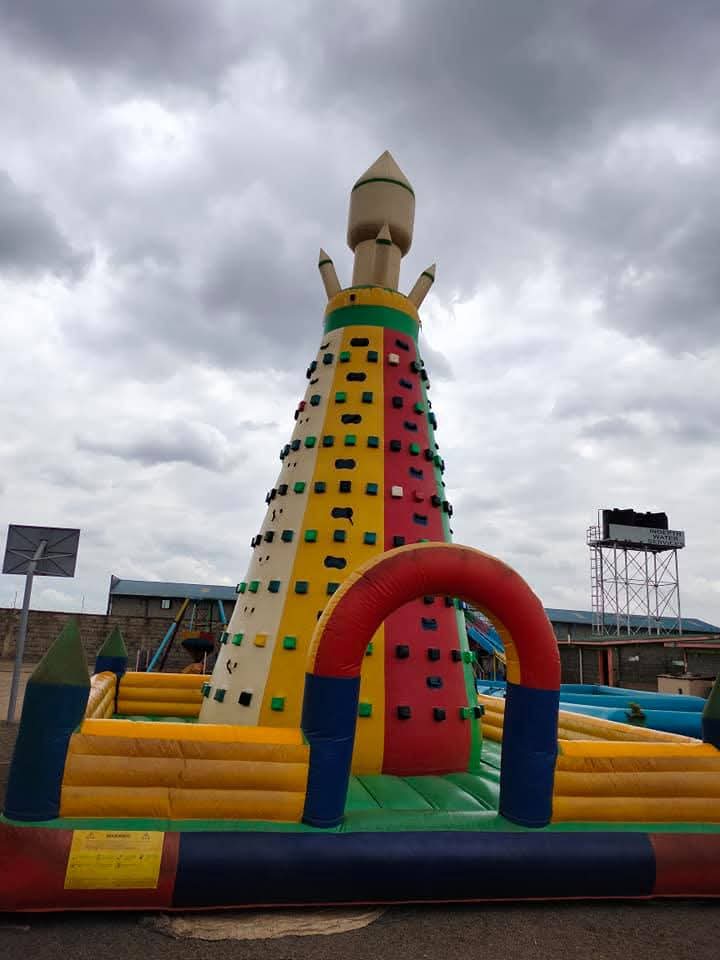 A tall inflatable climbing game with colourful hand holds at Vipe Fun Park