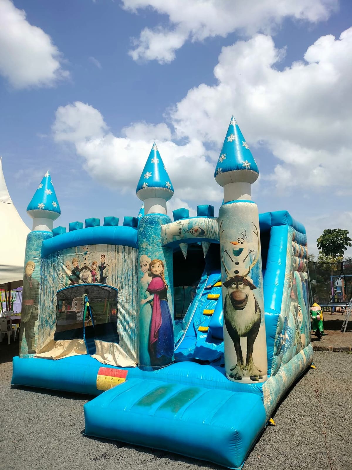 A large blue ice-castle themed bouncing castle with a slide at Vipe Fun Park