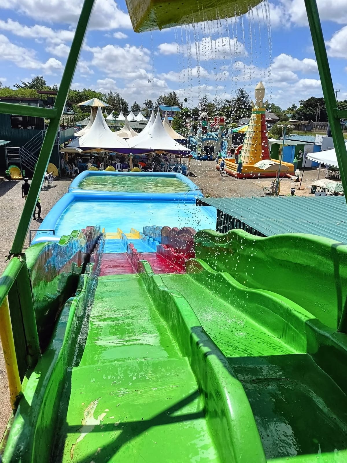 The view down the green water slide towards the splash pool at Vipe Fun Park