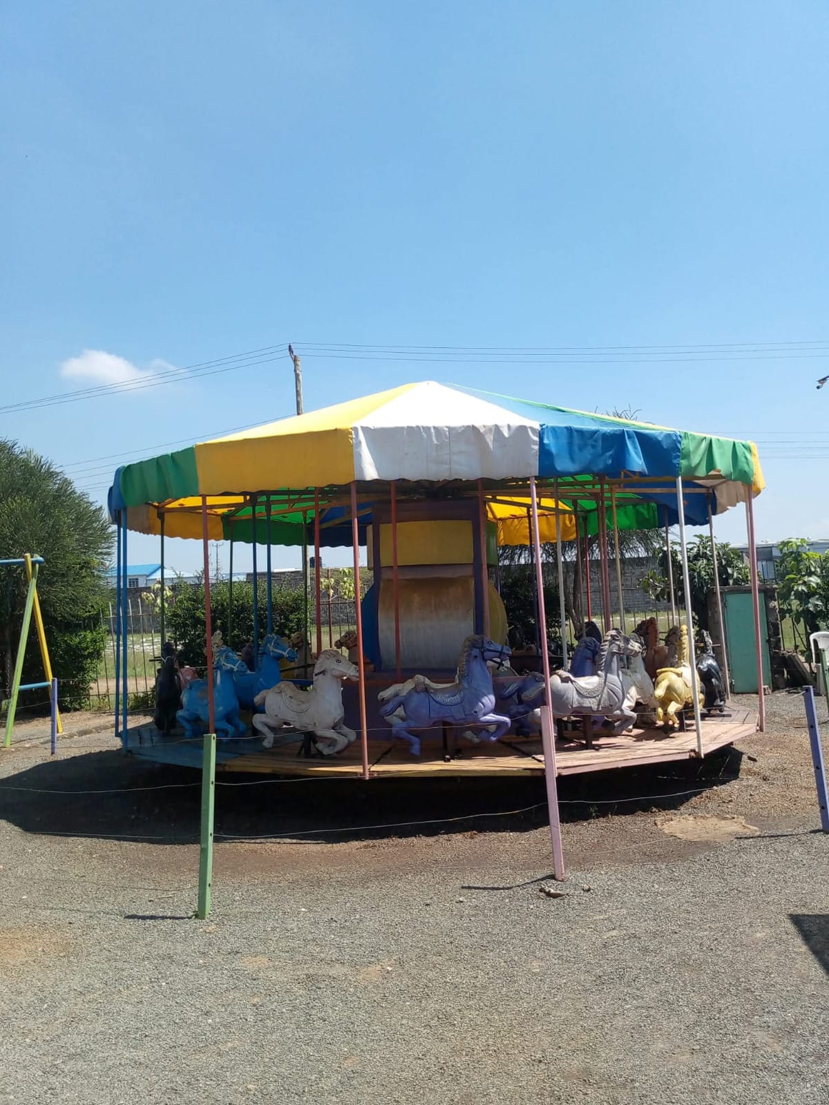 The colourful horse carousel at Vipe Fun Park under a clear blue sky
