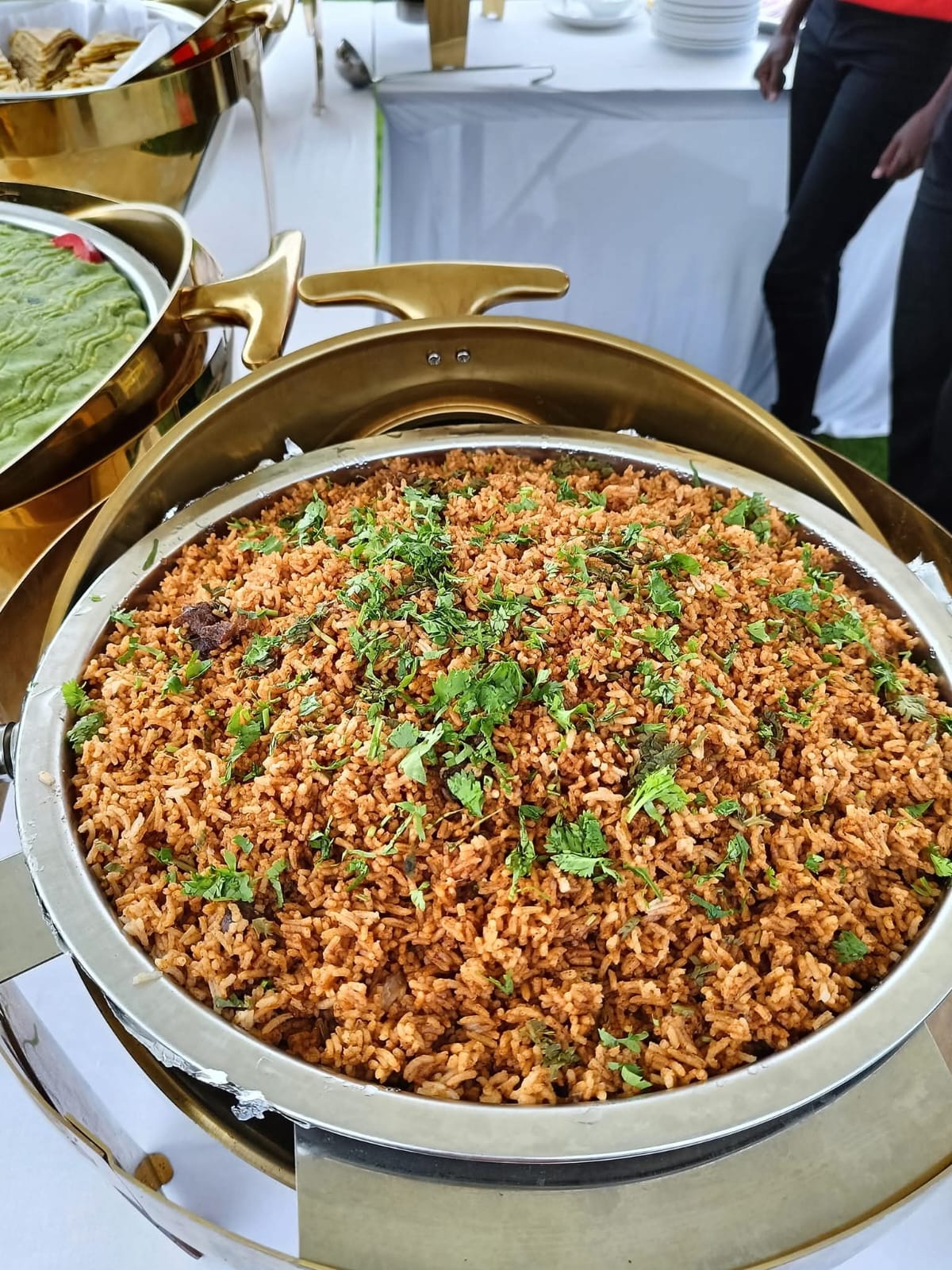 A large serving dish of spiced rice topped with fresh coriander at Vipe Fun Park