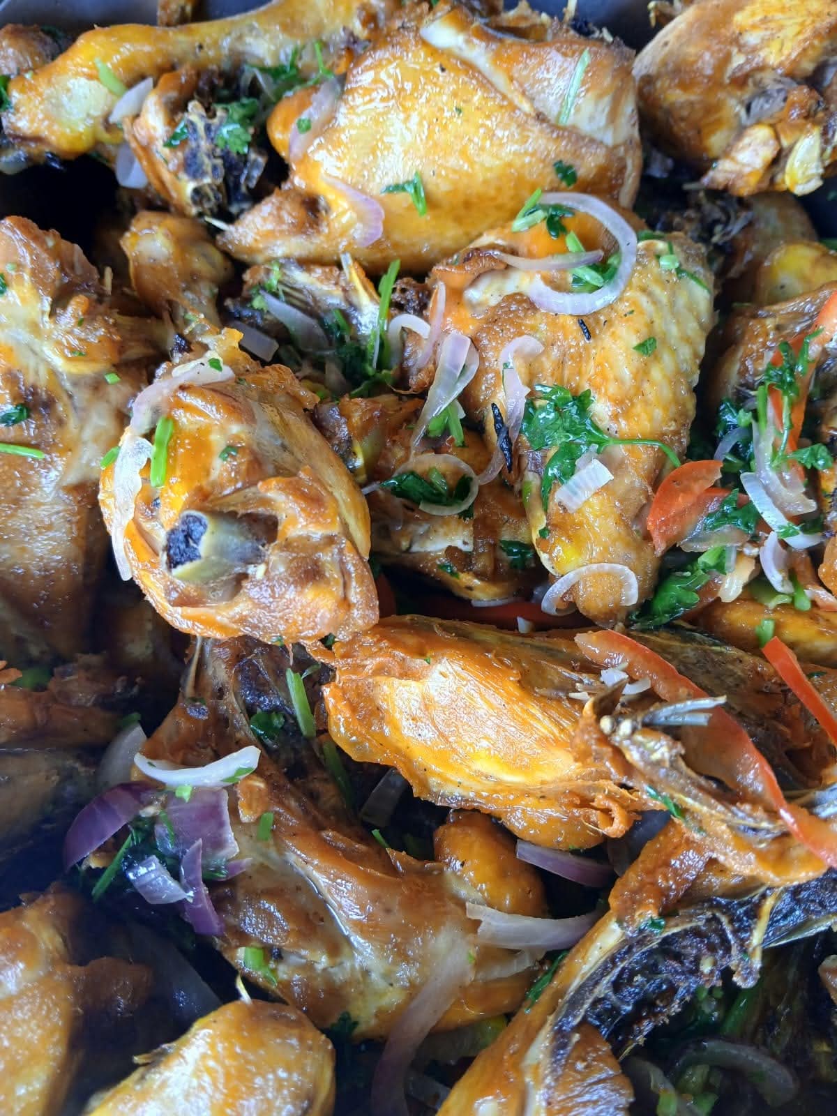 Chicken pieces cooked with onions, tomato and coriander in a serving tray at Vipe Fun Park